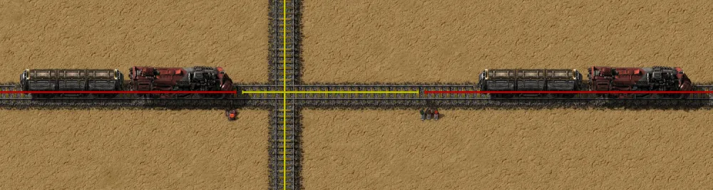 A wiki screenshot of a level crossing where one train has stopped short of the intersection, held by a chain signal, while a second train crosses freely on the perpendicular line