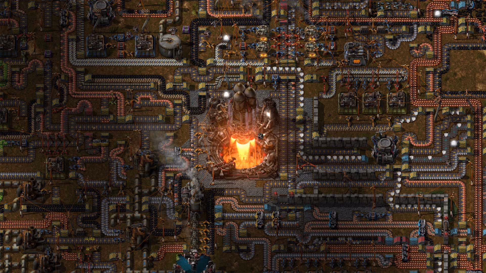 A sprawling Factorio base viewed from above, belts and pipes threading between assemblers toward a rocket silo mid-launch at the centre