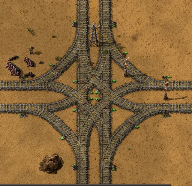A wiki screenshot of a four-way rail interchange, with curved crossover tracks linking two double-track main lines so trains can switch between them in either direction