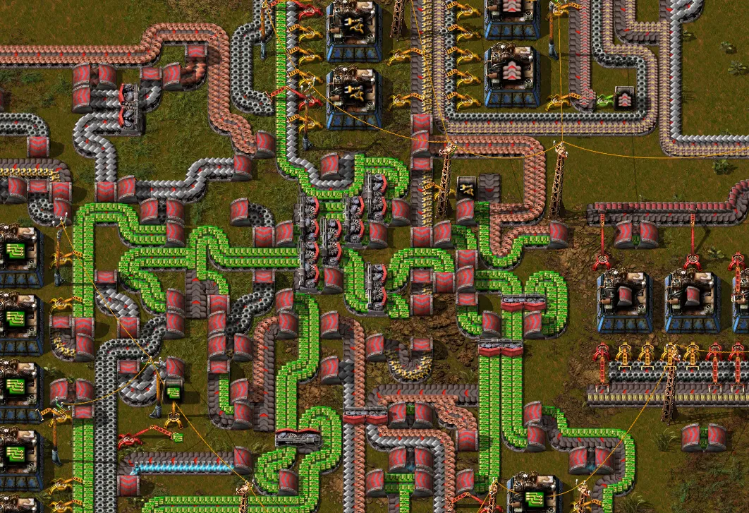A tangle of crossing belts, pipes, and power poles feeding several machines with no visible organizing structure