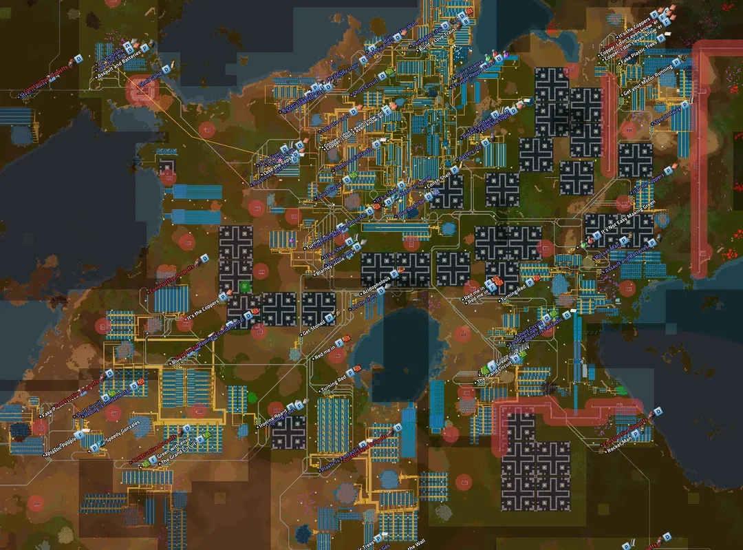 A wiki screenshot of a sprawling, non-tiled megabase spread across varied terrain, built up gradually with visibly mismatched production areas