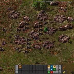 A wiki screenshot of a dense cluster of biter nests and worms spread across open grassland, the target a player approaches on foot before any turrets go down