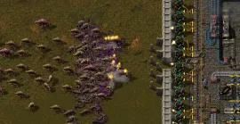 A wiki screenshot of a dense mass of biters attacking a defensive line, with turret muzzle flashes visible along a factory's edge