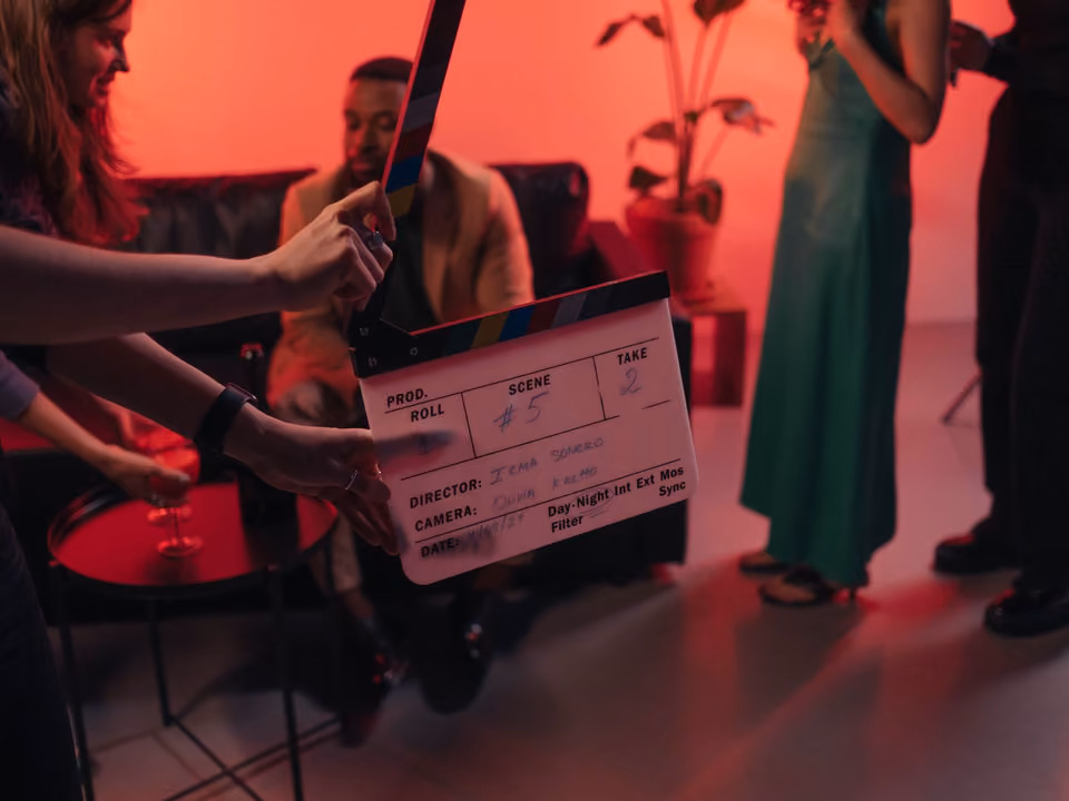 A clapperboard held up on a film set, marking a take