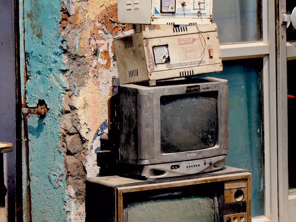 A stack of vintage box-style television sets