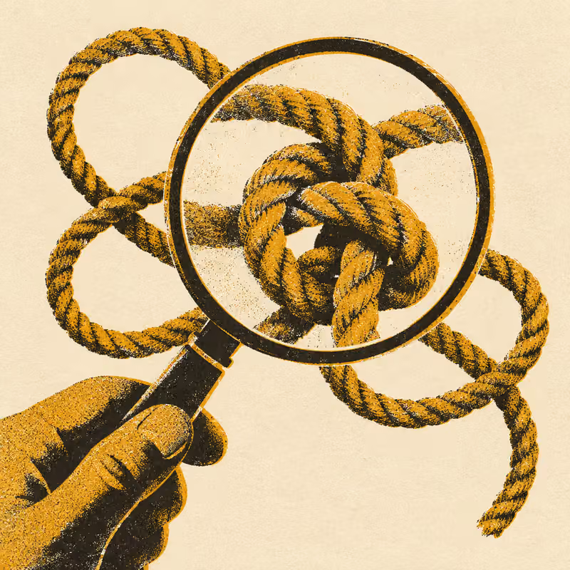 A magnifying glass held over a tangled knot of cord