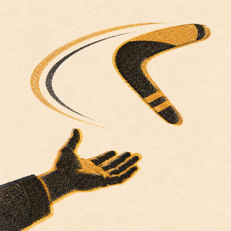 A boomerang mid-flight, curving back toward the open hand that threw it