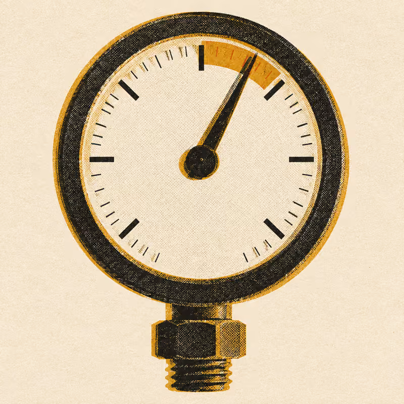A pressure gauge with its needle pinned into a red zone near the top of the dial