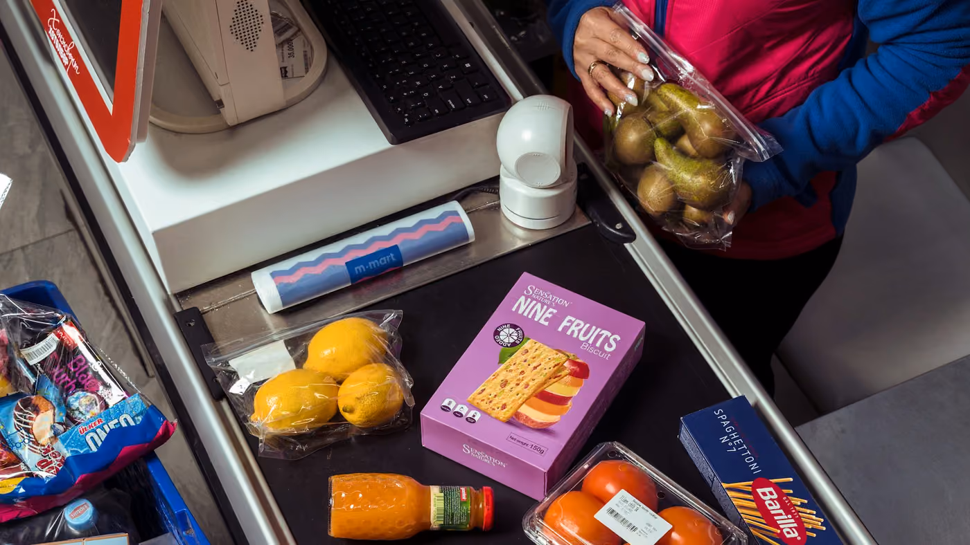Groceries moving along a belt towards a supermarket checkout
