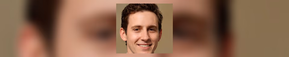 A photographic portrait of a man with short side-parted brown hair, smiling and facing the viewer against a plain tan background.