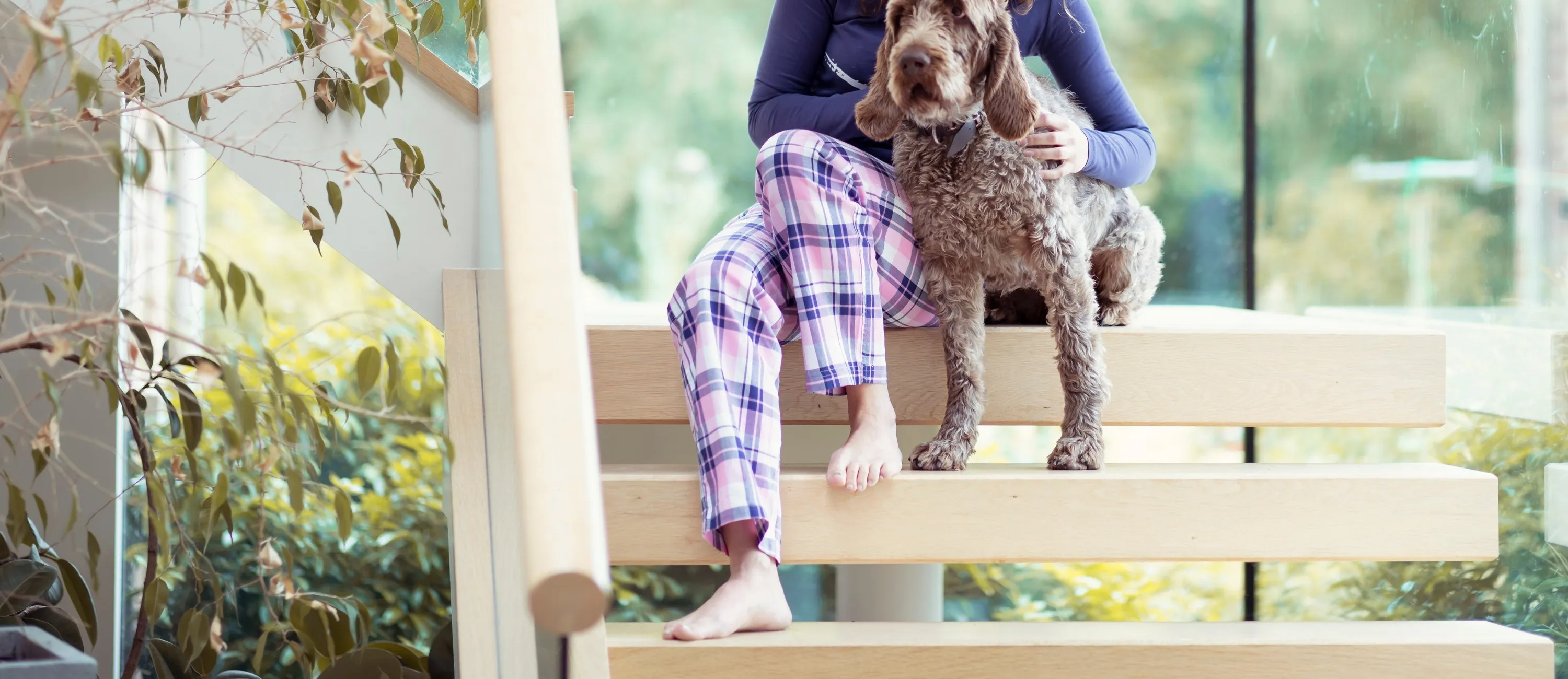 Loungewear outfit: a long-sleeve top and plaid pyjama trousers, worn
barefoot