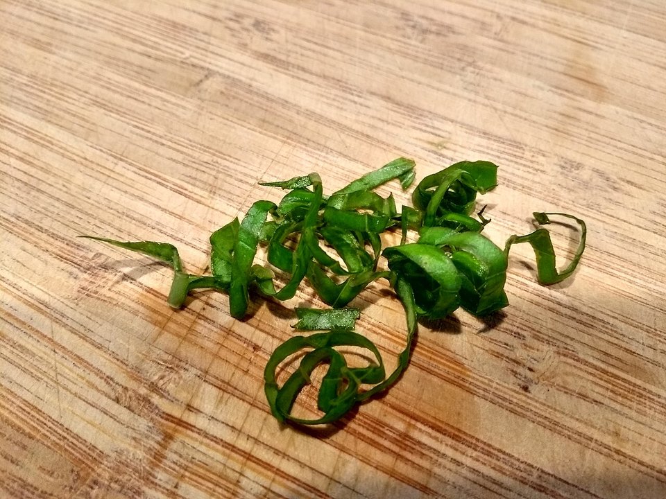 Basil leaves rolled and sliced into chiffonade ribbons