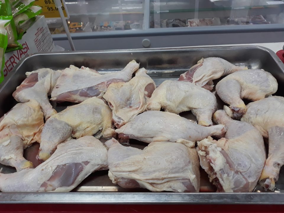 Raw chicken leg quarters, thigh and drumstick still jointed together, separated from the rest of the bird
