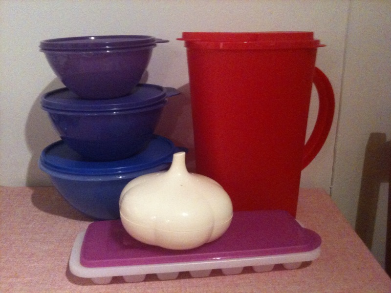 Stacked plastic food storage containers with lids, used to hold prepared food