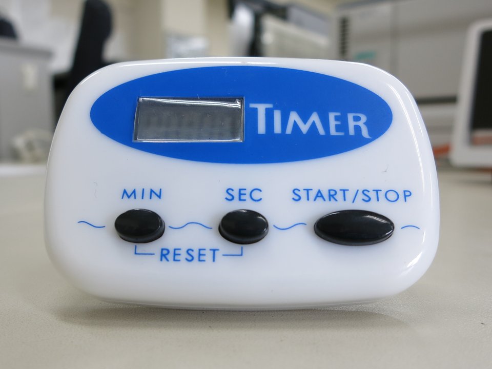A kitchen timer, the check against which the two-hour and one-hour limits are read