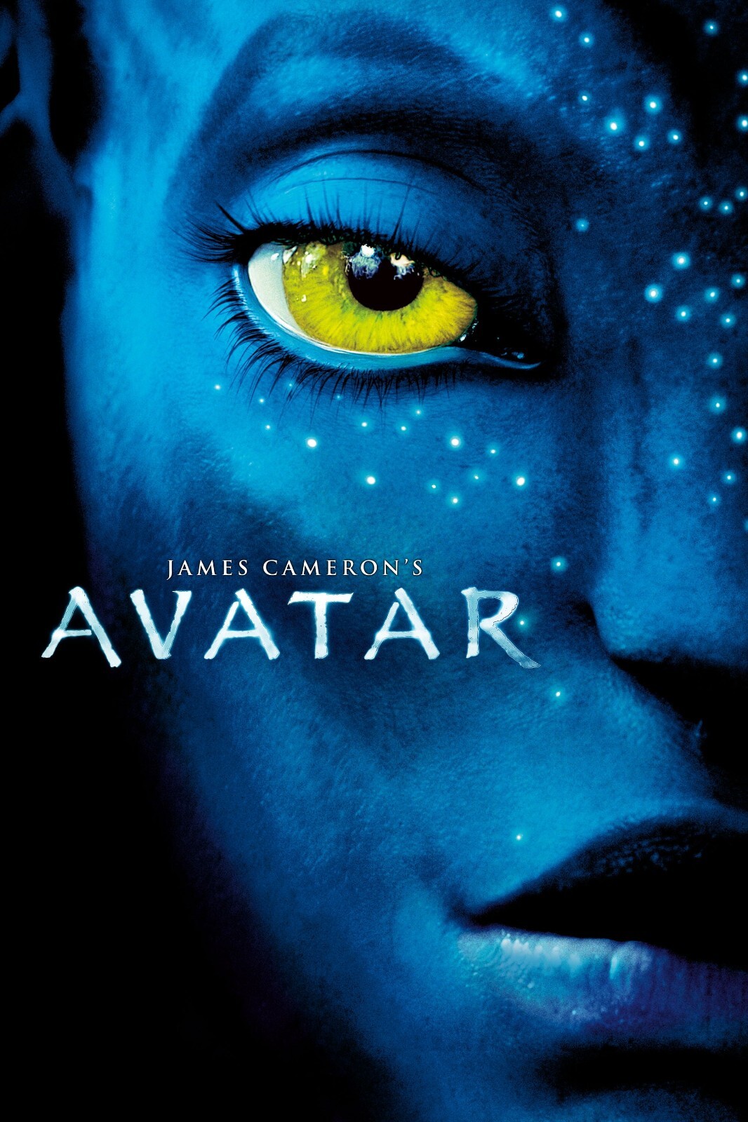 Theatrical poster. A close crop of a blue Na'vi face, one yellow eye wide, faint luminous flecks across the skin; "James Cameron's AVATAR" in white beneath it