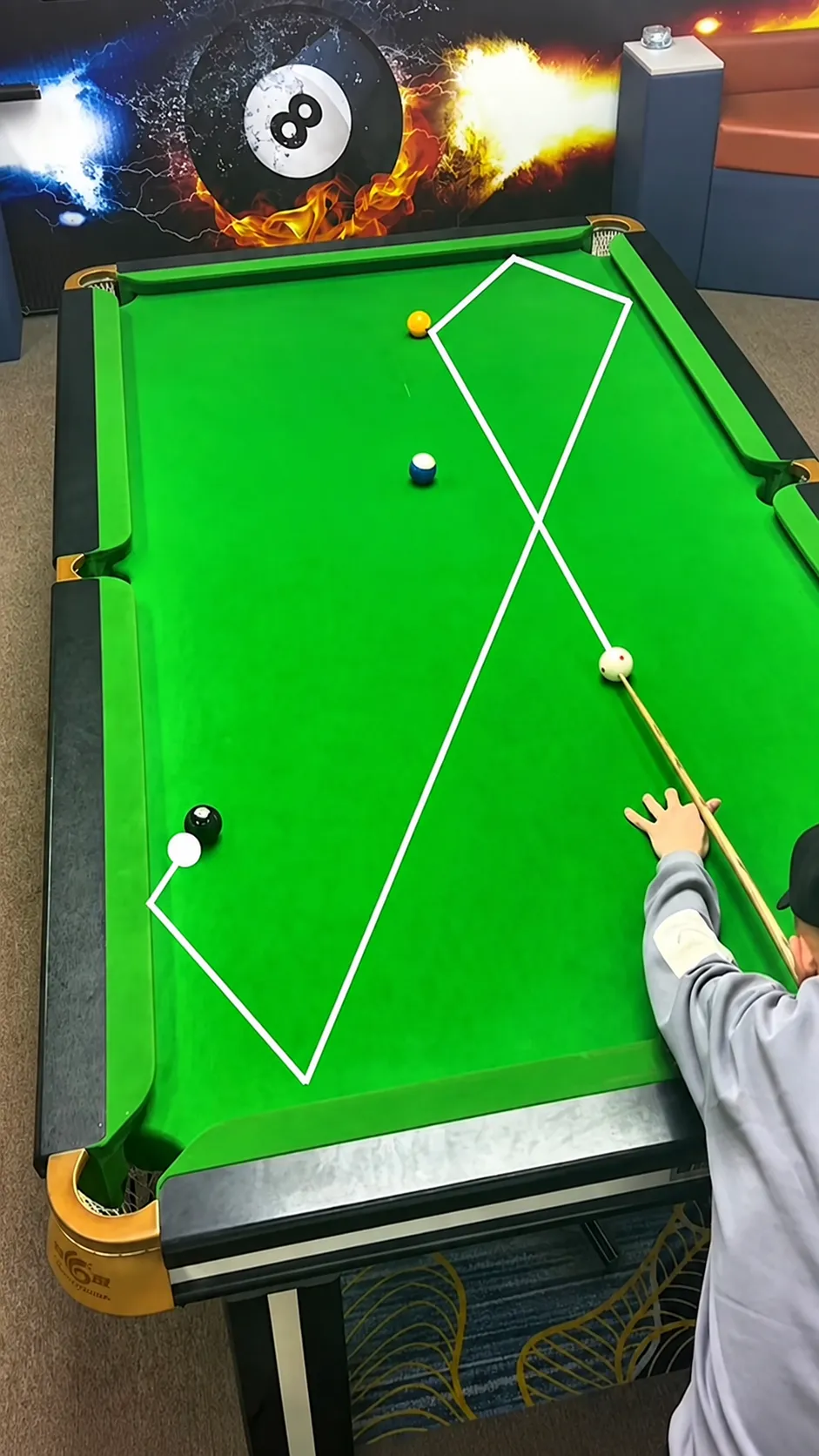 Overhead table diagram of one example safety route: a multi-rail cue-ball path chosen to leave the cue ball away from an easy follow-up shot.