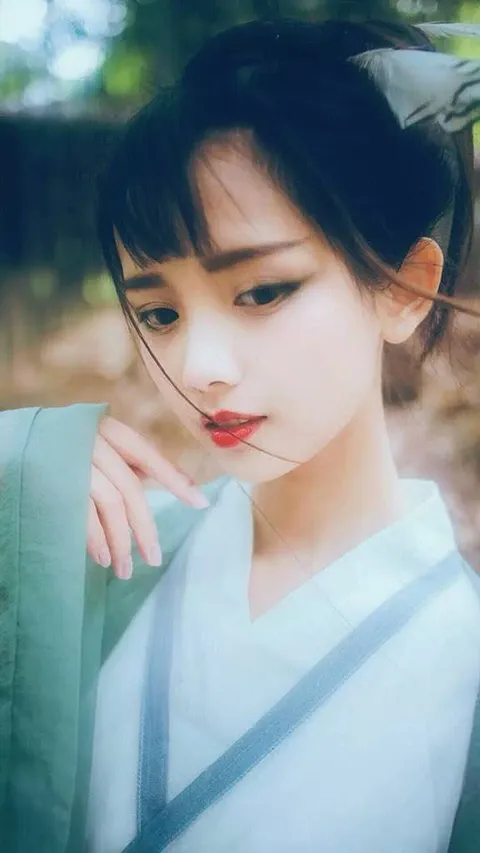 Portrait of Neko Azusa in pale blue traditional dress.