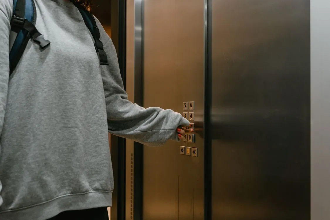 Bad manner: a hand reaches for the elevator panel as the doors are already
closing.