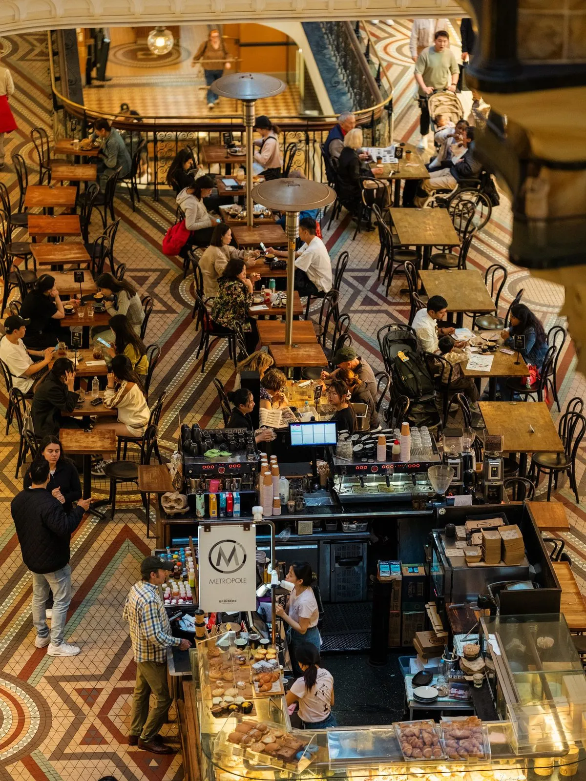 Good manner: a packed café, every table earned by someone actually seated
at it.
