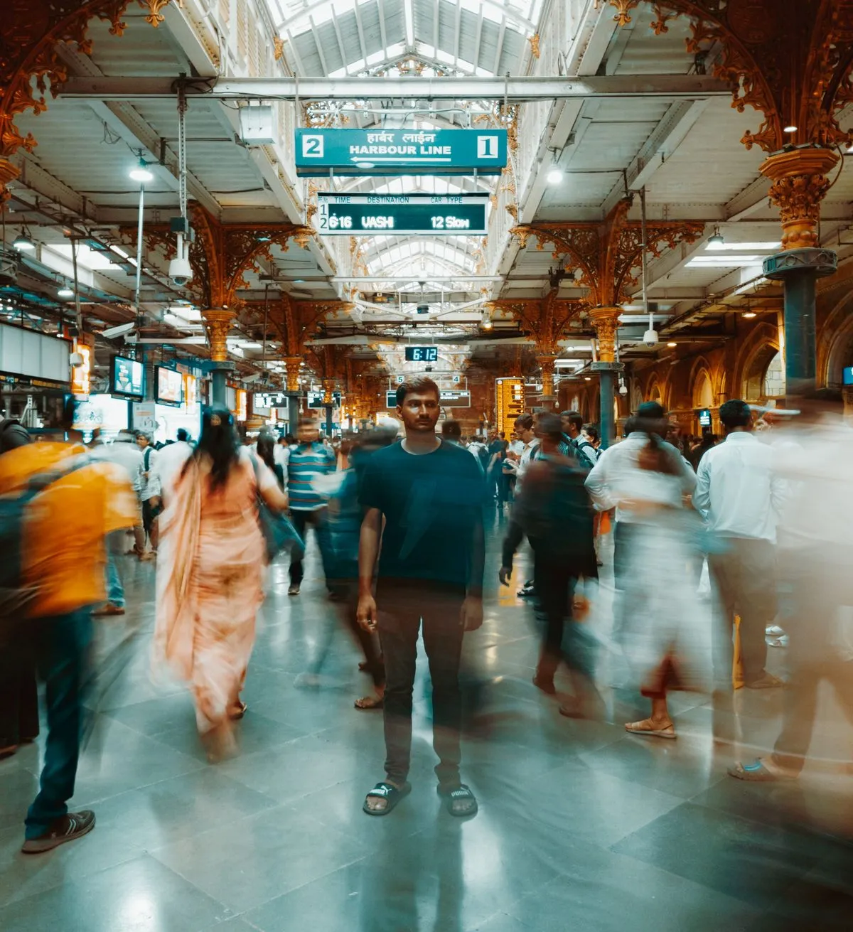 Good manner: one man standing still off to the side in sharp focus while
the surrounding crowd keeps moving past him,
unbroken.