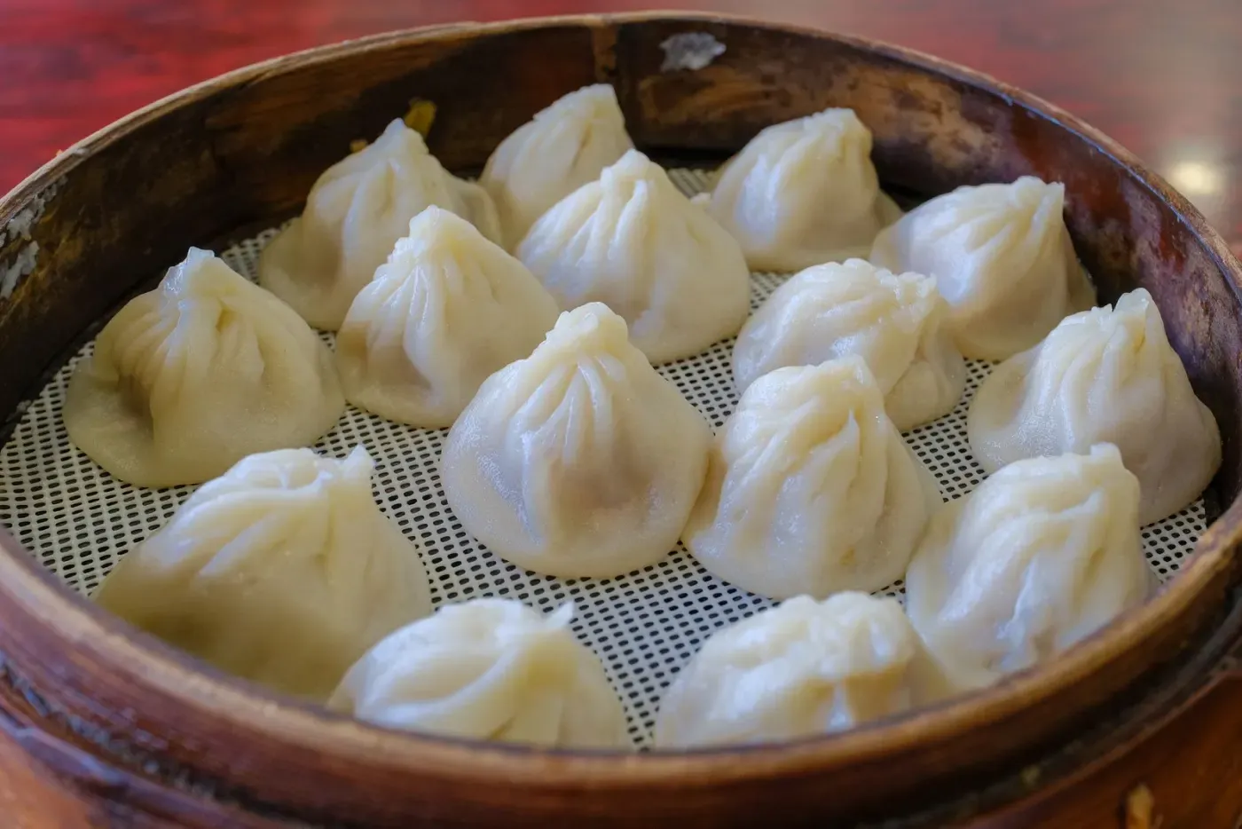 Traditional dumplings sitting in a bamboo steamer
