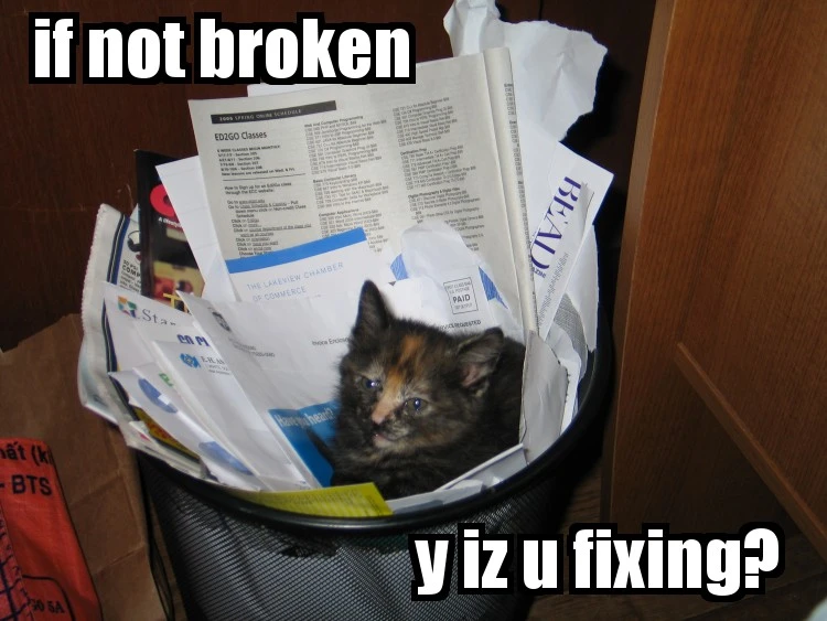 A kitten sits among papers in a wastebasket. The meme reads “if not broken” at the top and “y iz u fixing?” at the bottom.